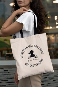 Tote bag natural con asa negra con la ilustración del personaje Lectorix y el texto "Me gustan más los libros que personas"