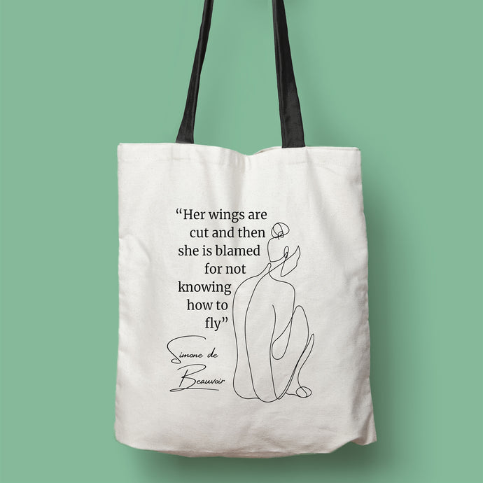 Tote bag color natural con asa negra de la colección Quotes & Co con ilustración de silueta de mujer y cita de Simone de Beauvoir.