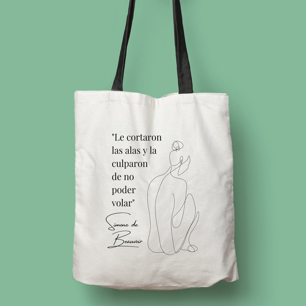 Tote bag color natural con asa negra de la colección Quotes & Co con ilustración de silueta de mujer y cita de Simone de Beauvoir.