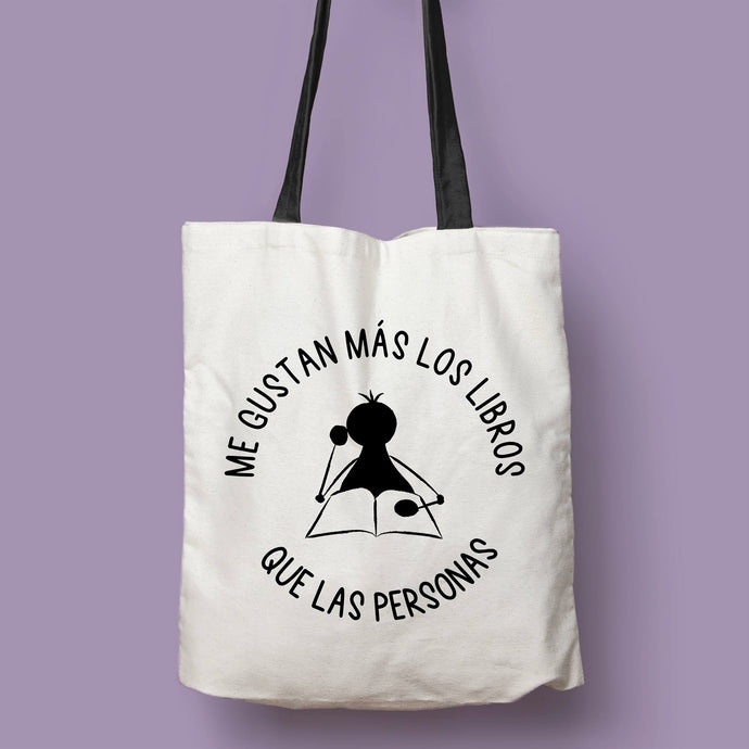 Tote bag natural con asa negra con la ilustración del personaje Lectorix y el texto 