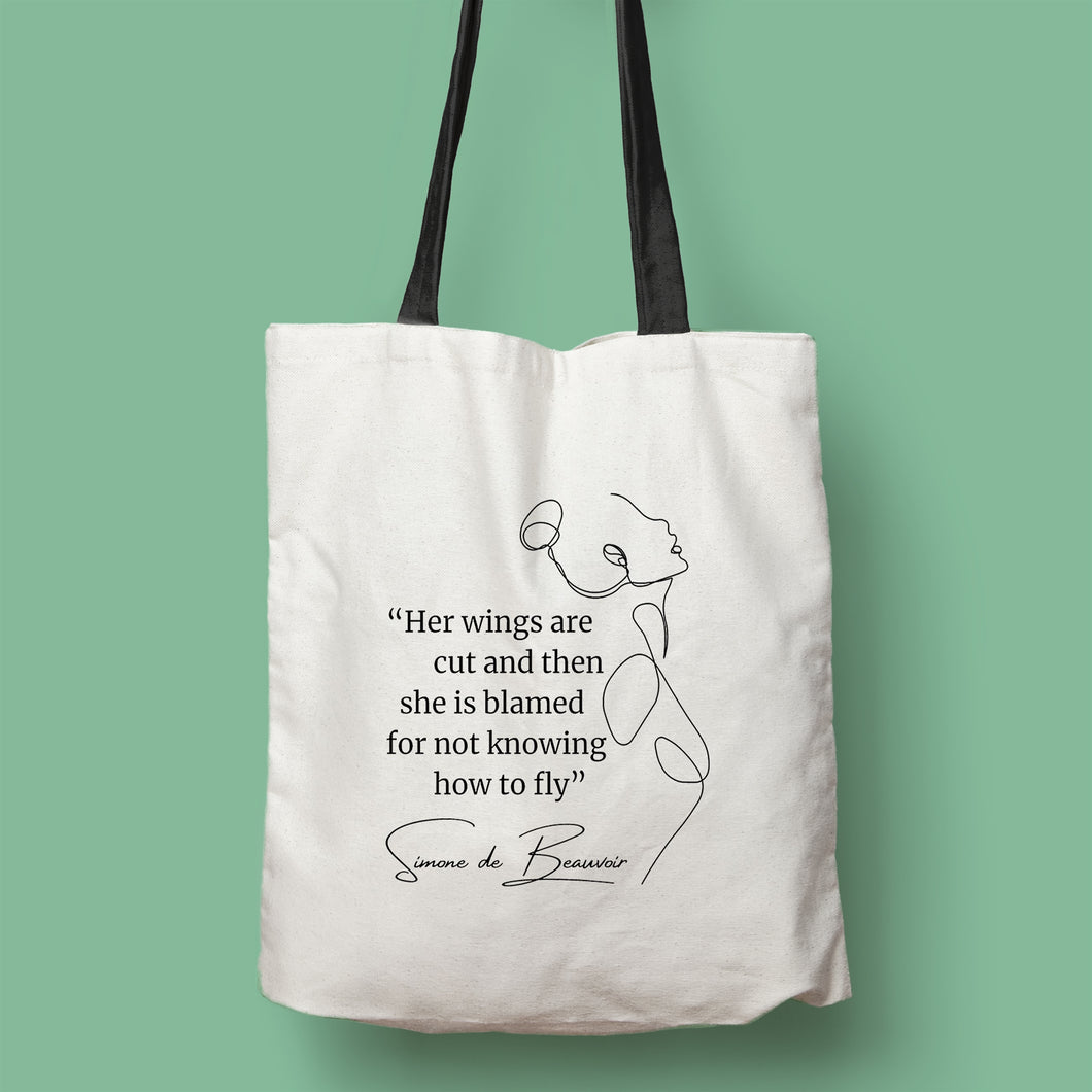 Tote bag color natural con asa negra de la colección Quotes & Co con ilustración de silueta de mujer y cita de Simone de Beauvoir.